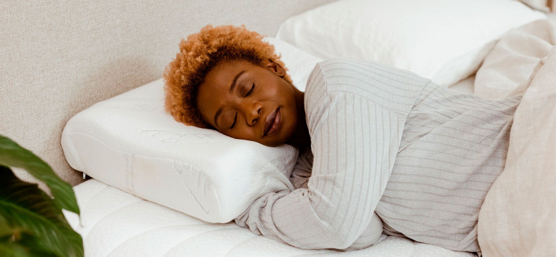 A woman sleeps on a latex pillow.