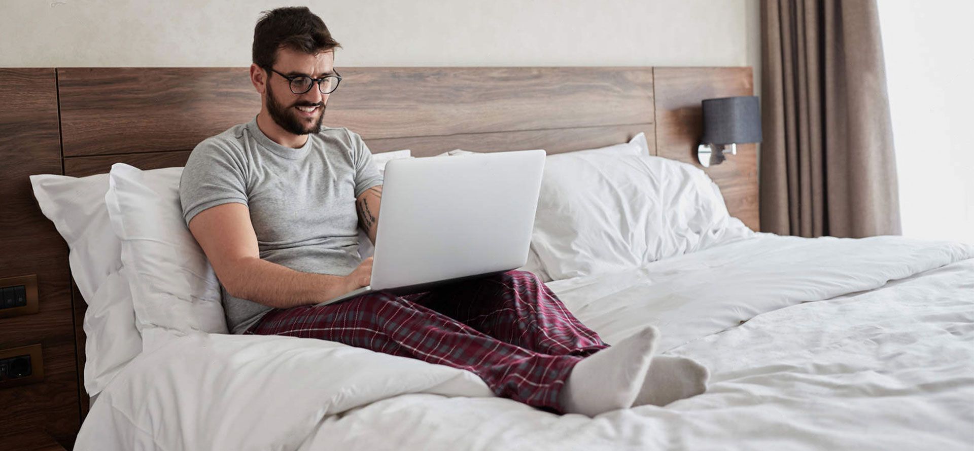 Man with laptop on the mattress.