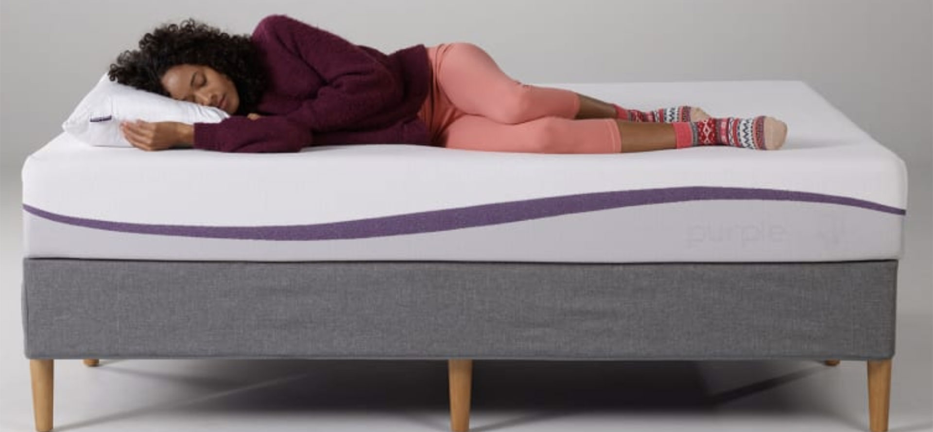 Woman with herniated disc on mattress.