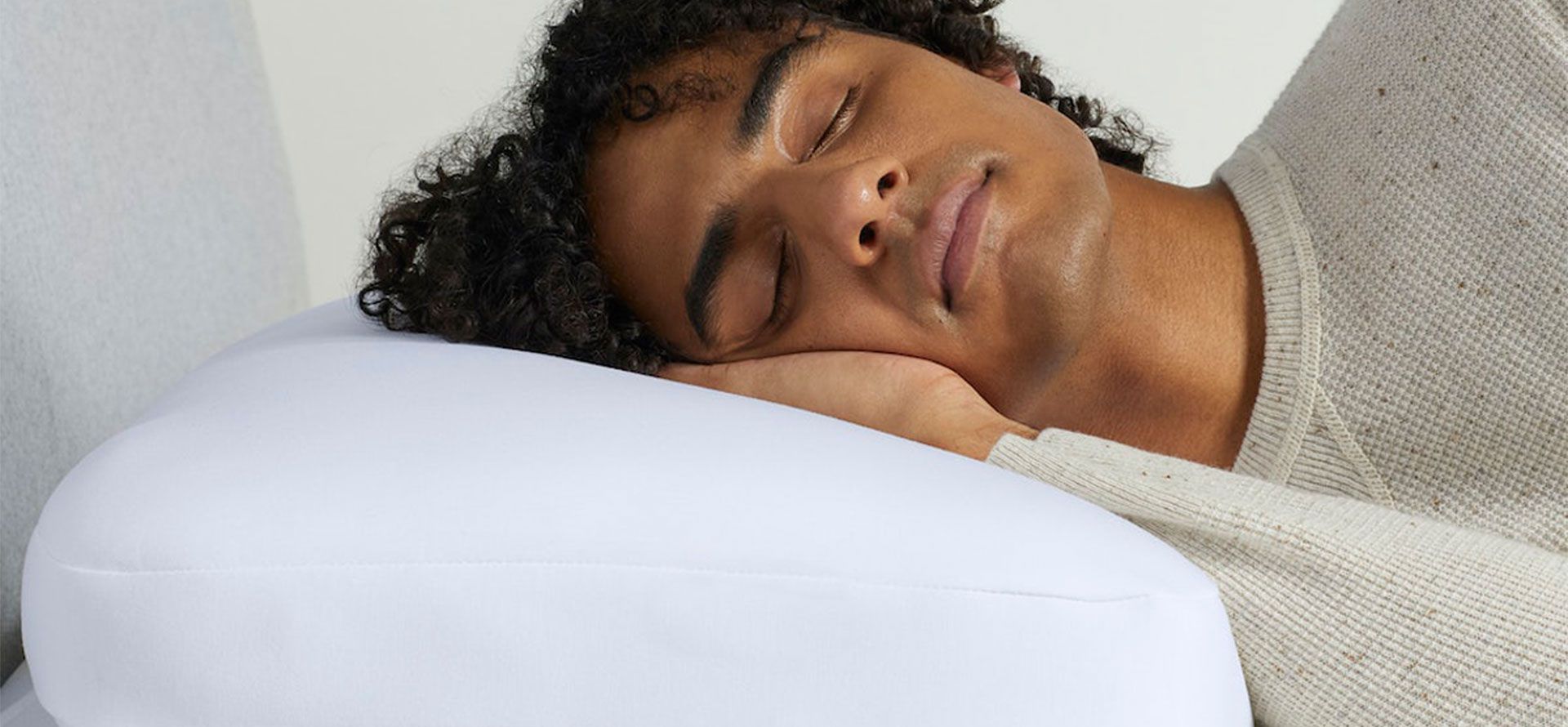 A man sleeps on a memory foam pillow.