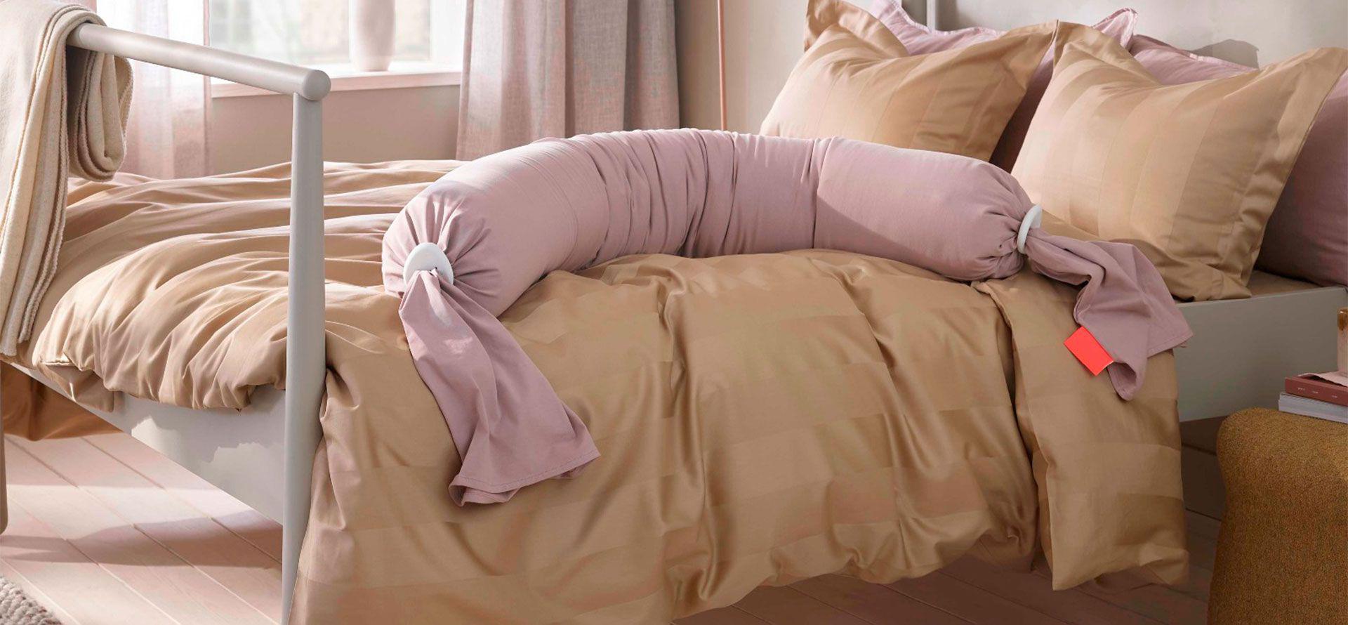 Pregnancy pillow on the bed.