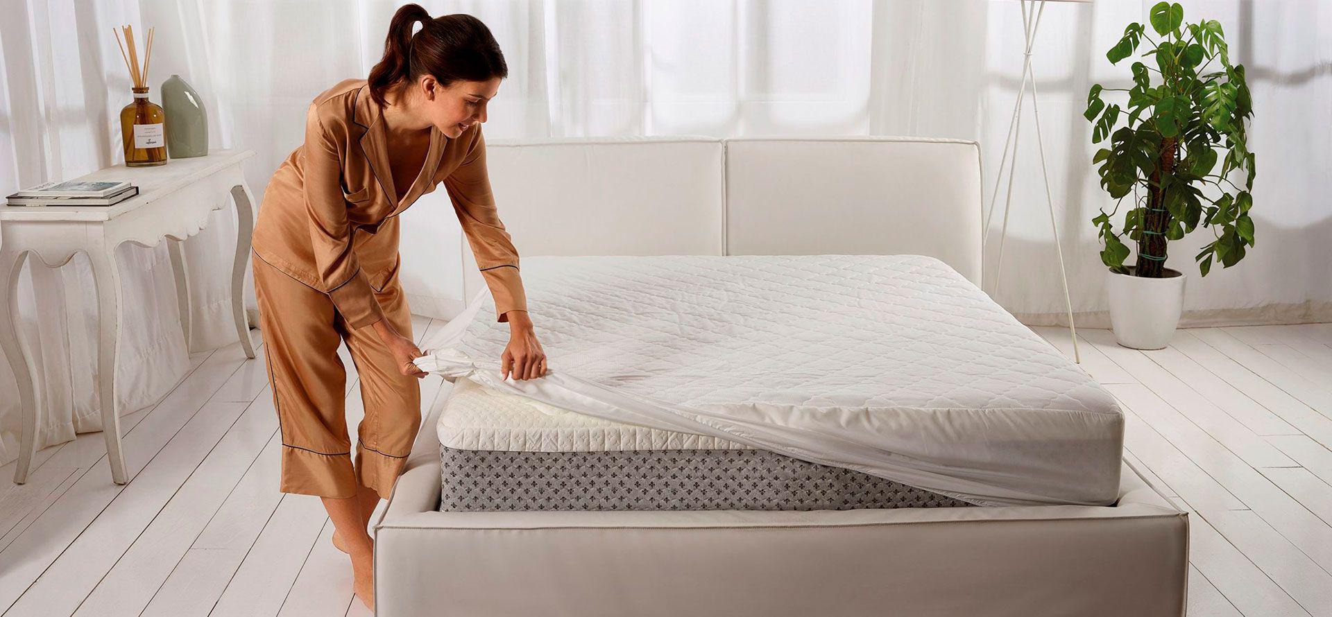 A woman changes her mattress.